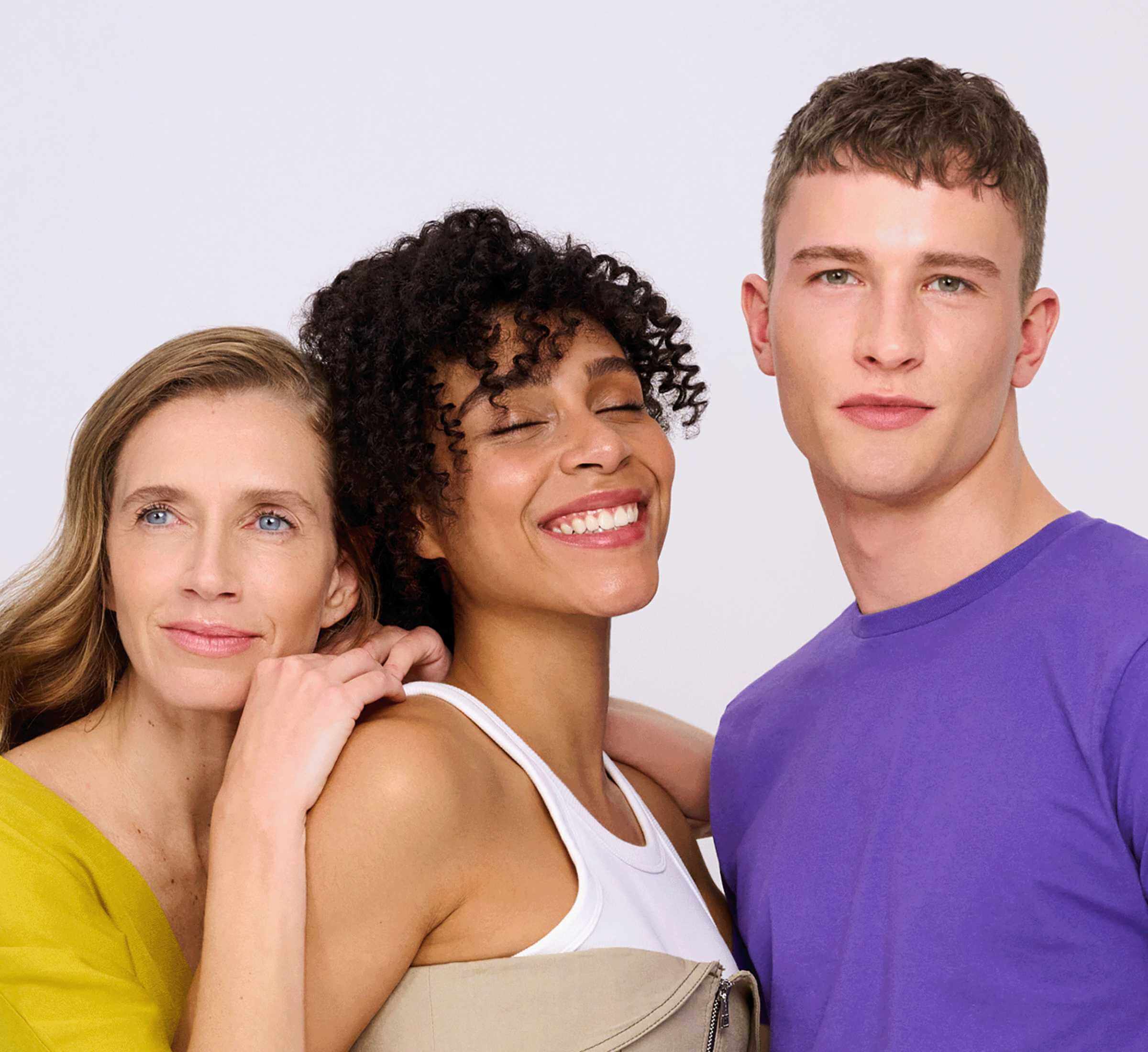 Drei Personen stehen in einer harmonischen, natürlichen Umgebung. Sie lachen miteinander und vermitteln ein Gefühl von Gemeinschaft, Gesundheit und Wohlbefinden. Warme, erdige Farbtöne unterstreichen das Konzept eines nachhaltigen und bewussten Lebensstils.